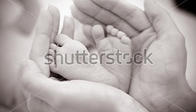 stock-photo-baby-feet-cupped-into-mothers-hands-109751450.jpg